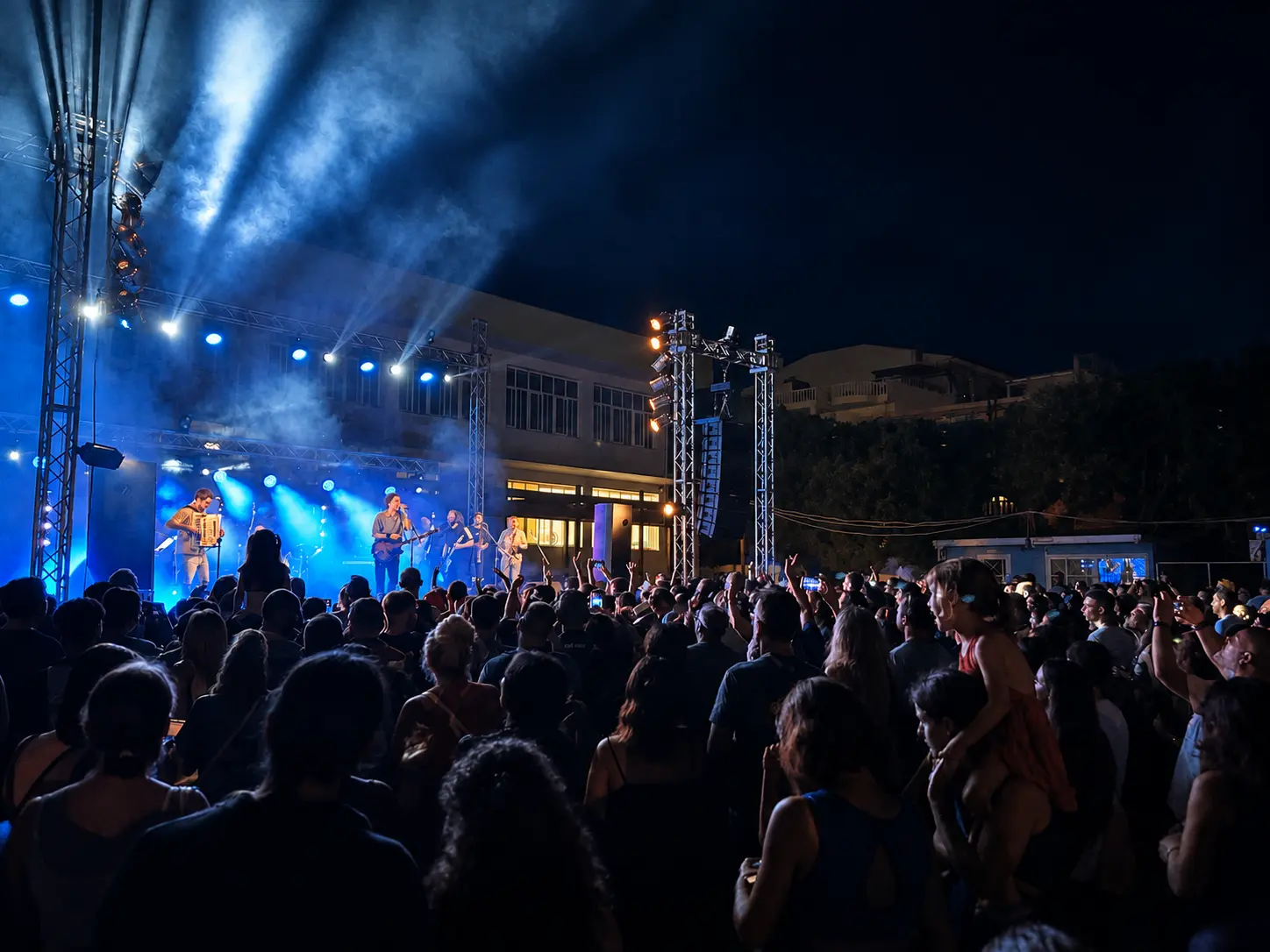 Live band performing to a large outdoor audience